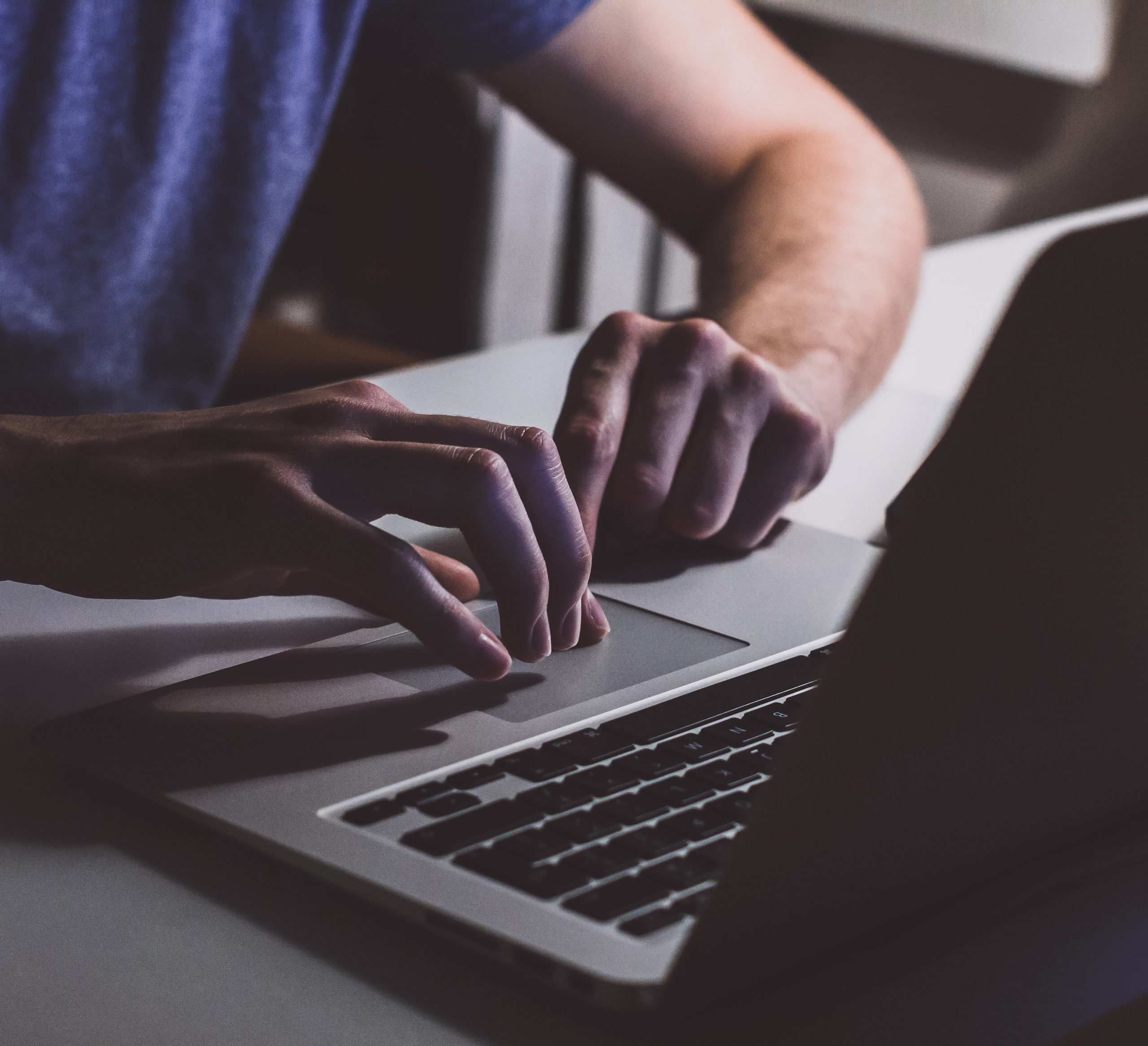 person-touching-open-macbook-on-table-839465 SQ
